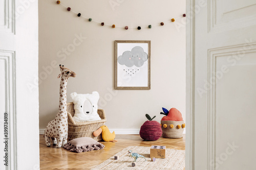 Stylish scandinavian kid room with mock up poster, toys, teddy bear, plush animal, natural pouf and children accessories. Modern interior with beige background walls. Template. Design home staging.