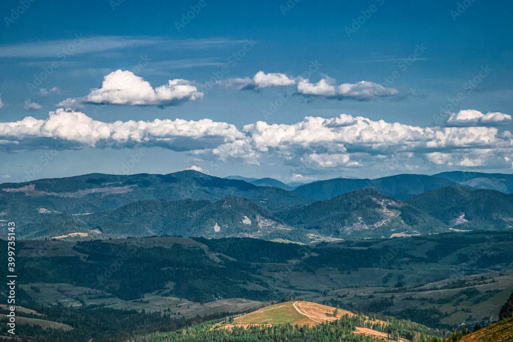 Beautiful summer panoramic landscape in mountain highlands with white clouds near Pylypets, Ukraine 