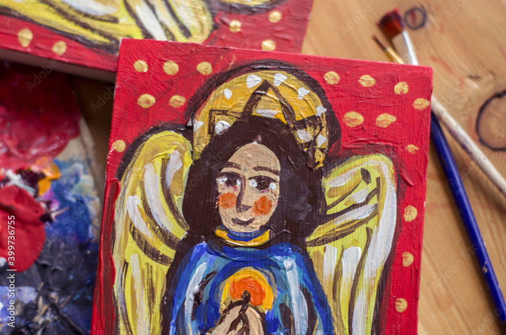 The angel is drawn on a board in ancient style of painting.