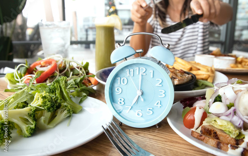 Selective focus of blue clock and Time to lose weight , eating control or time to diet concept. photo