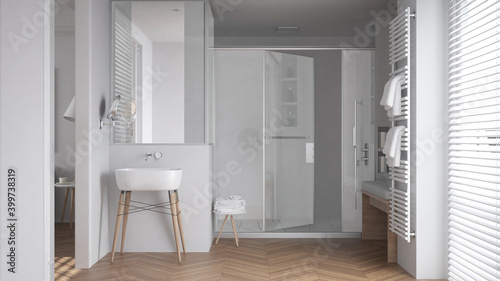 Minimalist bathroom in white tones with sink  large shower with glass cabin  heated tower rail with towels  herringbone parquet  window with venetian blinds  interior design concept