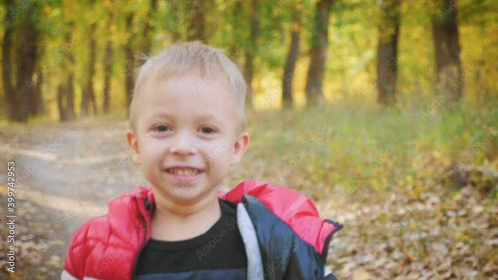 Happy baby boy running in autumnal park. Little child playing on autumn walk. Autumnal forest with golden leaves. Steadicam video, 4K slow motion. Happy baby boy running in autumnal park. Little child playing on autumn walk. Autumnal forest with golden leaves. Steadicam video, 4K slow motion.