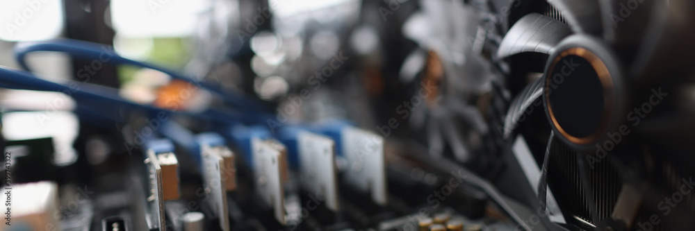Set of riser installed at pci express slots of cryptocurrency mining farm closeup Set of riser installed at pci express slots of cryptocurrency mining farm closeup