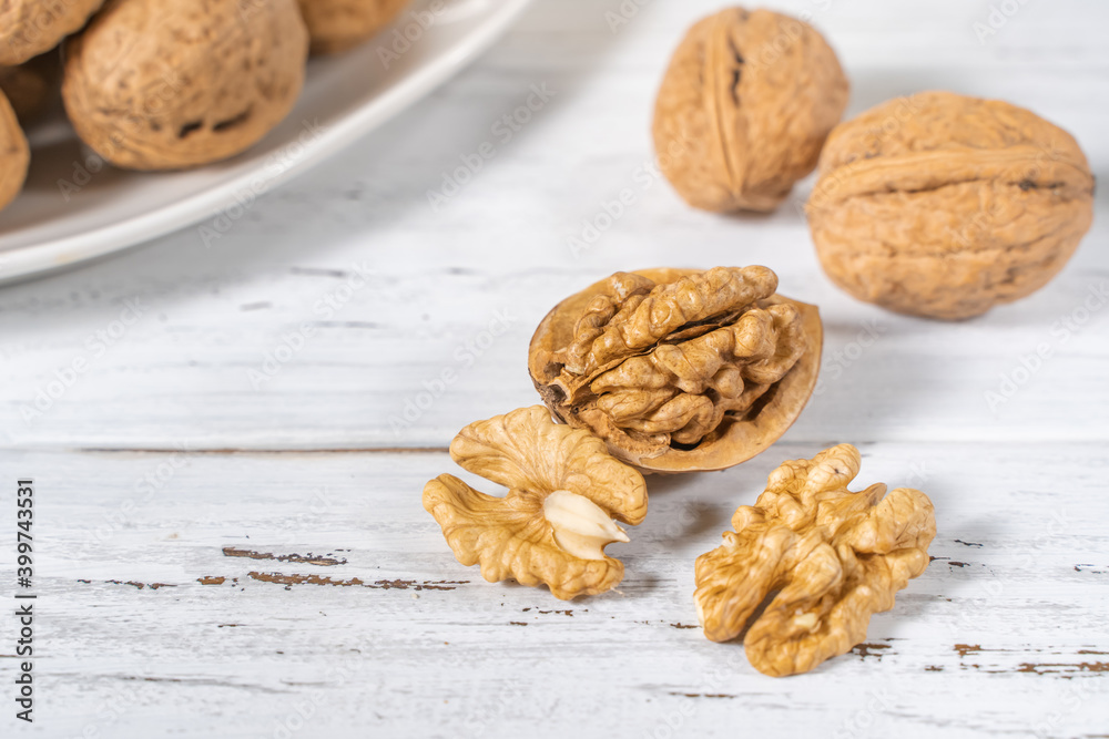 Walnuts kernels on white wooden desk, stock photo Walnuts kernels on white wooden desk, stock photo