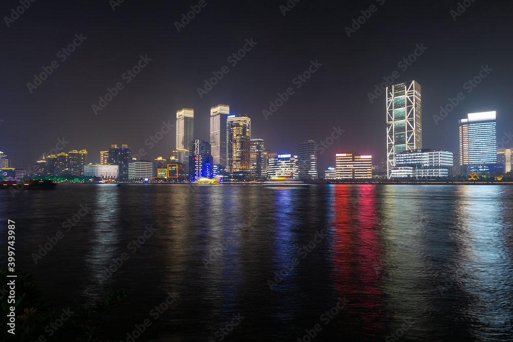 city in china is reflected in the river at night