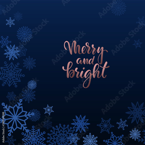 Merry and bright Hand drawn brush pen lettering in golden rose frame on blue background with snowflakes. Trendy template of Merry Christmas and Happy New Year greeting card