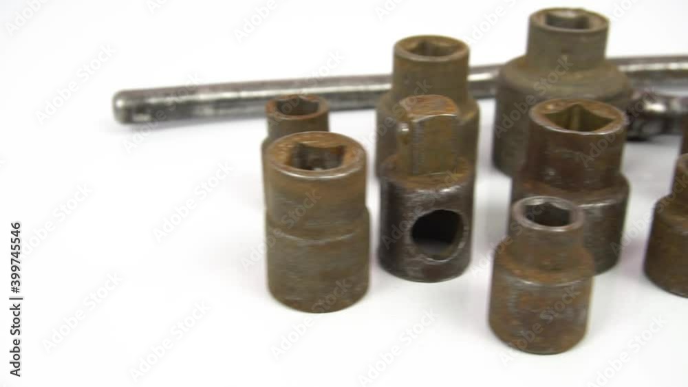 Socket heads, tools for loosening and tightening nuts. Old wrenches covered with rust. Dolly shot on white isolated. Socket heads, tools for loosening and tightening nuts. Old wrenches covered with rust. Dolly shot on white isolated.