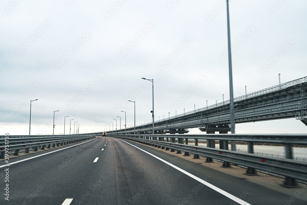 Empty highway with asphalt road and cloudy sky