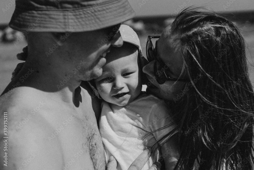 Fototapeta premium Happy family spends time by the sea. Happy together. Black and white photo