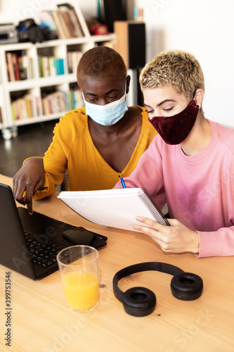 Businesswomen with protective mask using laptop