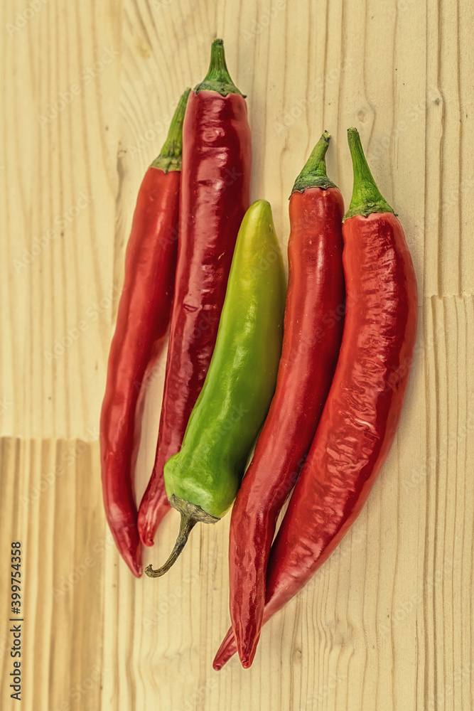 Red chili pepper and green pod on a wooden background a set of vegetables