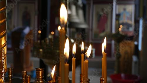 Church Candles Burns In Front Of Christian Icons 