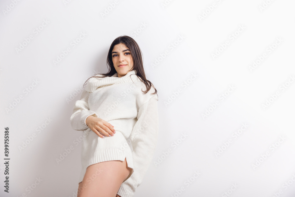 Attractive. Portrait of beautiful brunette woman in comfortable soft longsleeve isolated on white studio background. Home comfort, emotions, facial expression, winter mood concept. Copyspace. Attractive. Portrait of beautiful brunette woman in comfortable soft longsleeve isolated on white studio background. Home comfort, emotions, facial expression, winter mood concept. Copyspace.