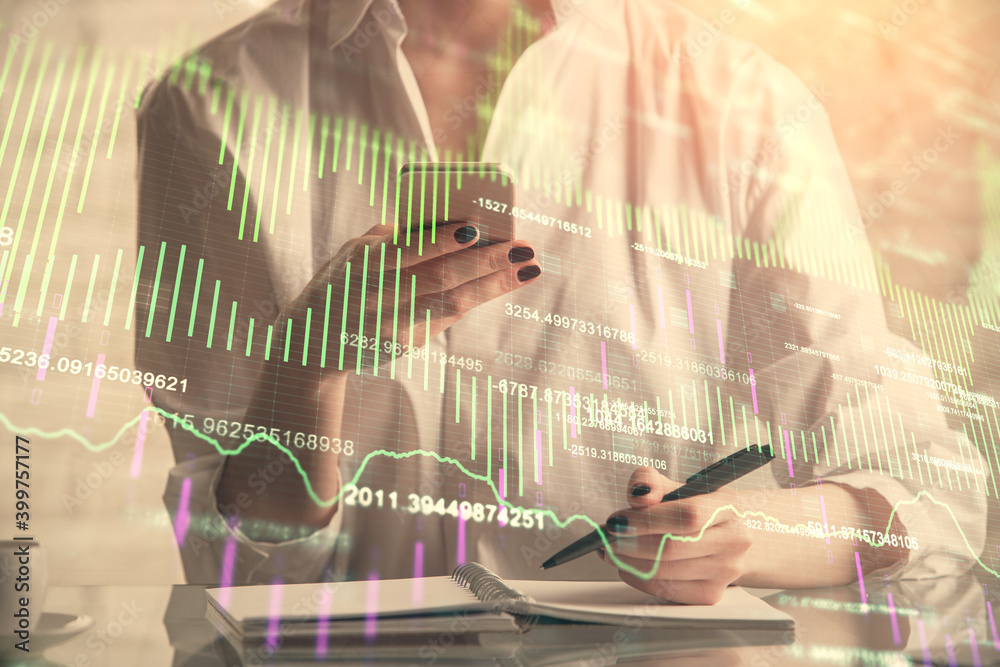 Obraz premium Double exposure of financial graph sketch hologram and woman holding and using a mobile device. Stock exchange concept.