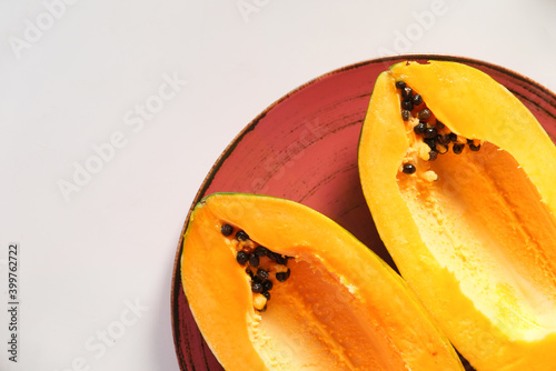 close up of slice of papaya on plate 