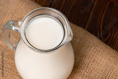 Glass jar of milk on old wooden table