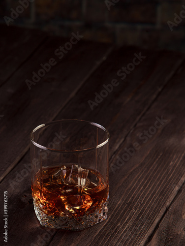 Whiskey drink on dark wooden table