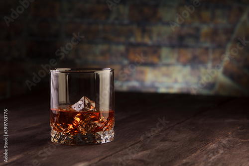 Whiskey drink on dark wooden table