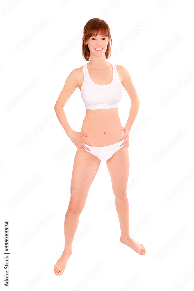 Full length portrait of a young athletic woman wearing a white bikini, isolated in front of white studio background Full length portrait of a young athletic woman wearing a white bikini, isolated in front of white studio background