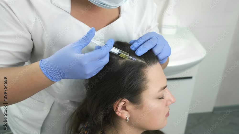 Doctor trichologist making injections mesotherapy with vitamins in