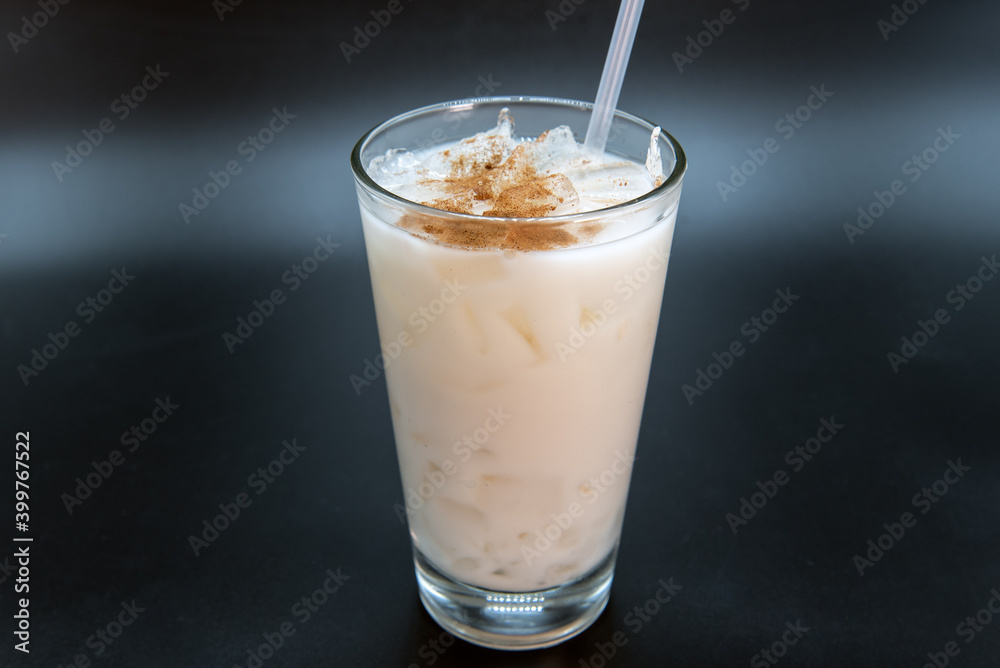 White horchata sweet drink sprinkled with sweetness and served in a clear glass with straw to quench your thirst. White horchata sweet drink sprinkled with sweetness and served in a clear glass with straw to quench your thirst.