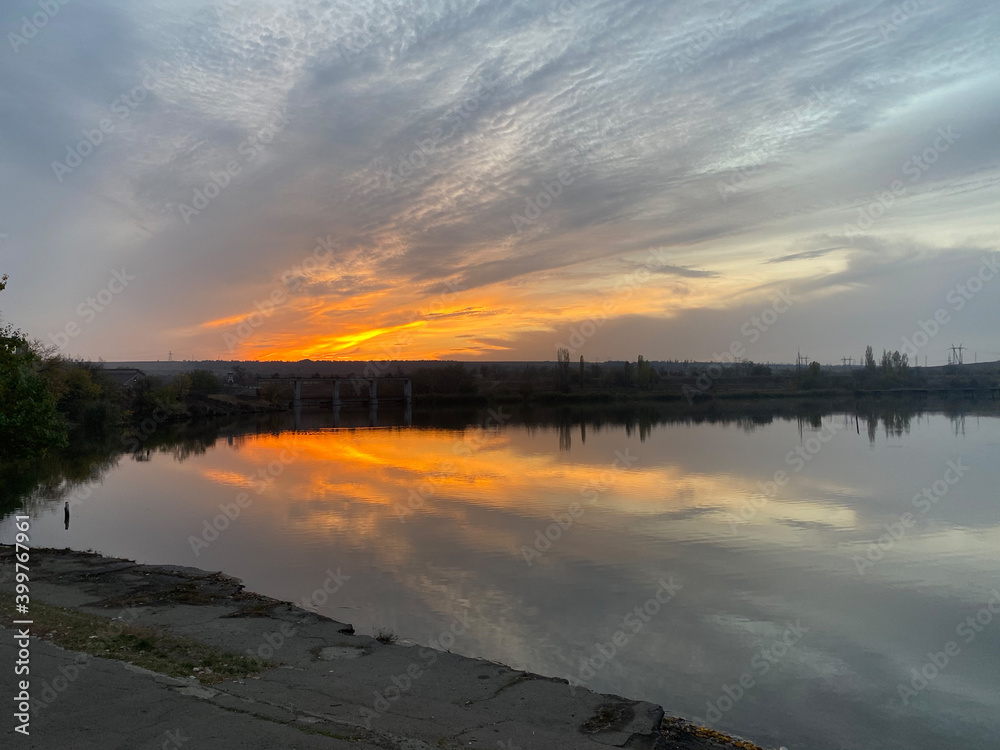 Naklejka premium sunset over the river