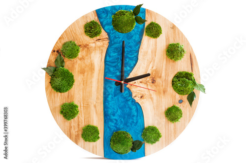 palette with paint and brush. Icelandic sterilized moss for decoration. Wooden large clock with epoxy resin and elements of moss