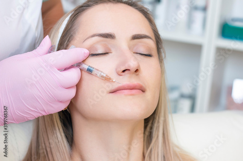 young woman receiving cosmetic injection. Woman in a beauty salon.