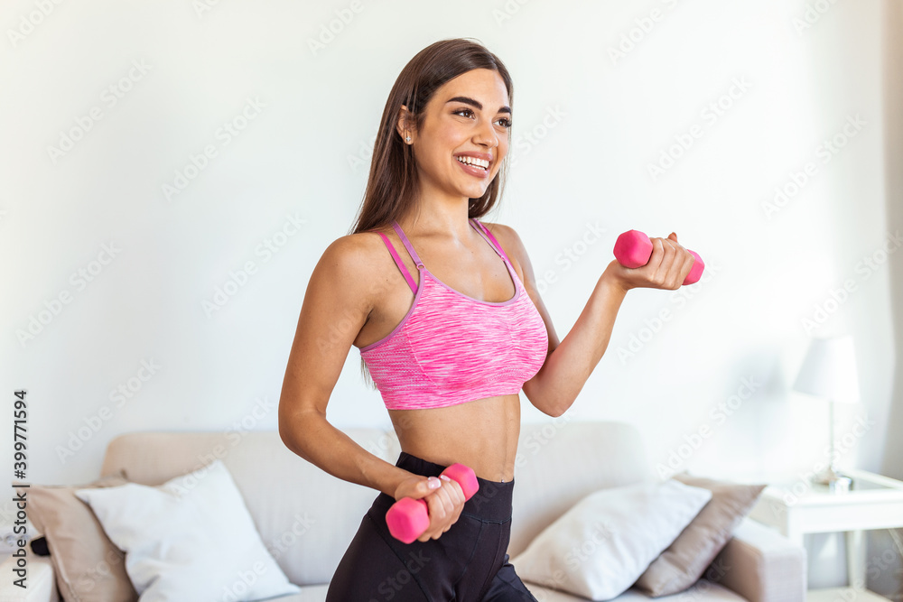 Strong fit woman working out with dumbbells. Attractive fit woman works out with dumbbells as a fitness conceptual. Active woman in sportswear working out. Strong fit woman working out with dumbbells. Attractive fit woman works out with dumbbells as a fitness conceptual. Active woman in sportswear working out.