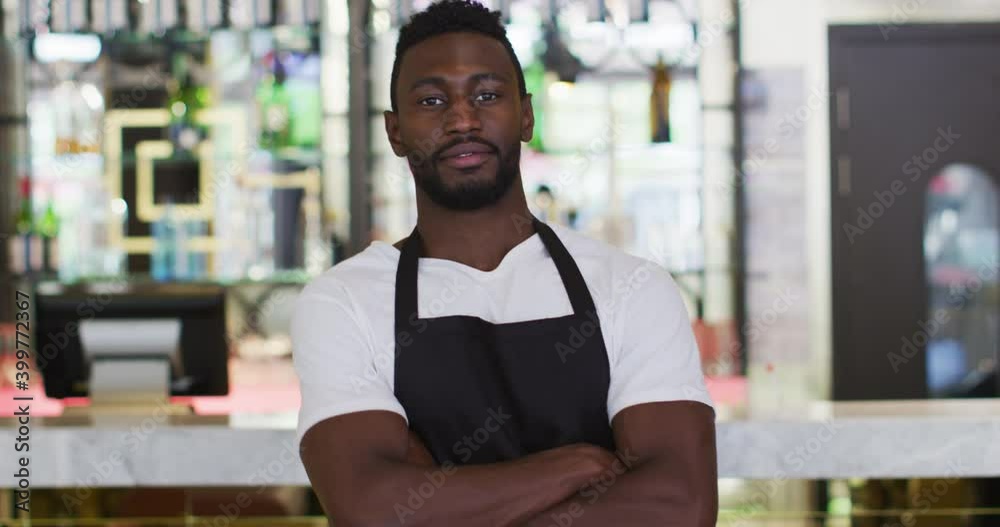 Portrait of african american barista smiling to camera wearing apron in cafe Portrait of african american barista smiling to camera wearing apron in cafe