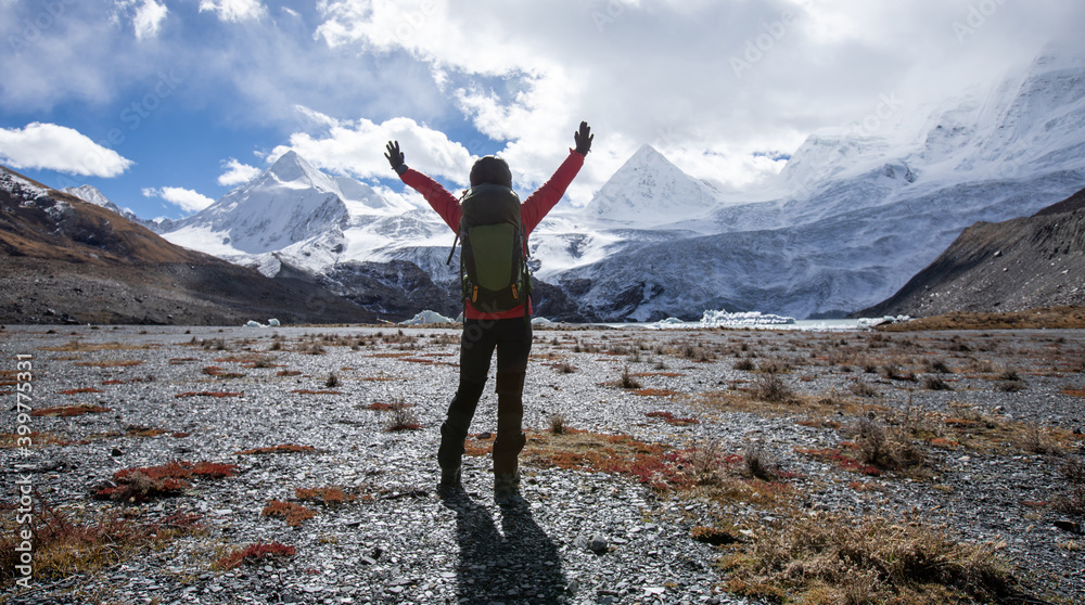 Fototapeta premium Woman backpacker hiking in winter high altitude mountains