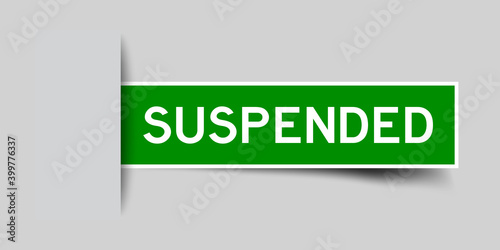 Inserted green color sticker label with word suspended on gray background