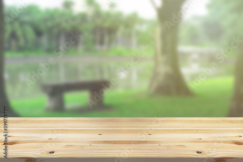 Empty wooden board  table in front of blurred background. Perspective brown wood over wind nature background - can be used mockup for display or montage your products. copy space.