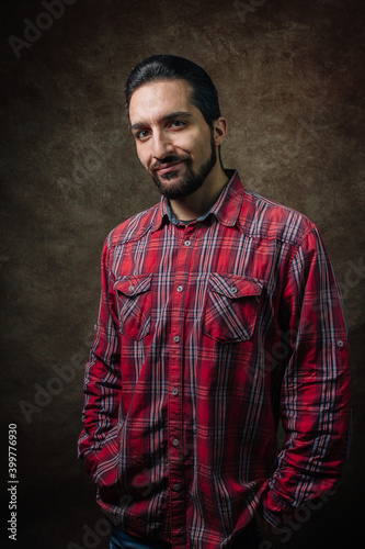 Portrait of a man. man in a red shirt. Portrait on a brown background.