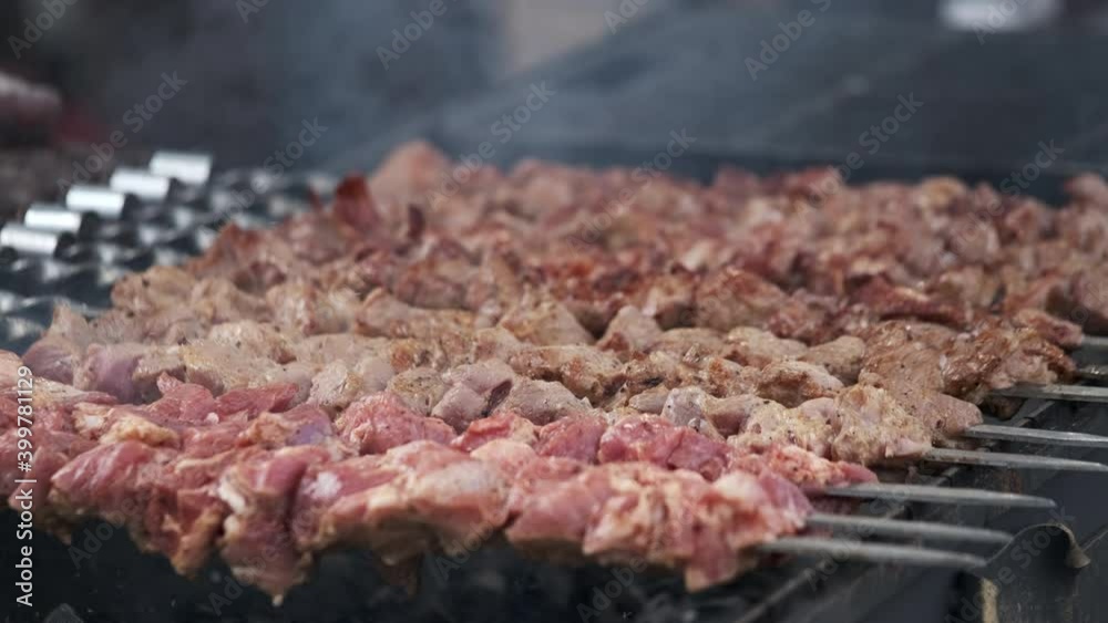 Grilling delicious meat skewers in smoke Grilling delicious meat skewers in smoke