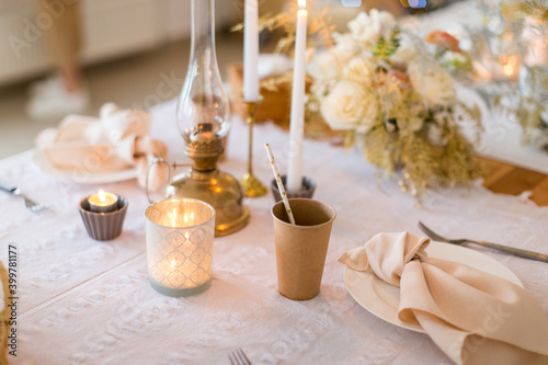 Christmas decoration of the festive table with cakes  glasses and candles