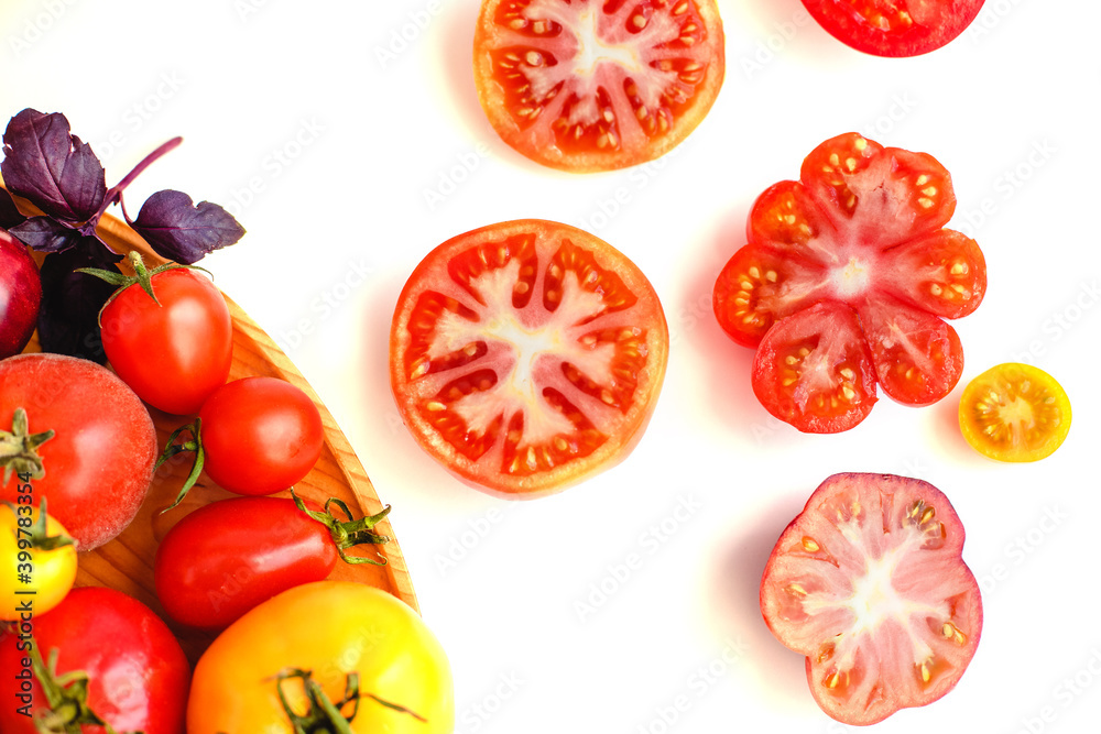 Fototapeta premium Different tomatoes on white. Vegetables of different varieties