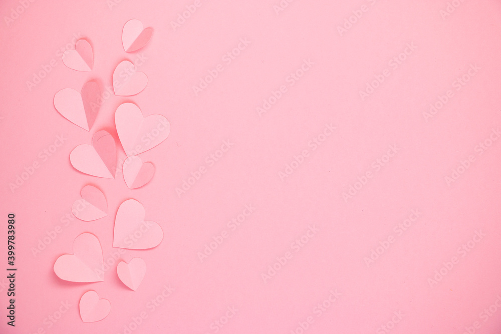 Paper cut hearts on pastel pink background. Composition for Valentine's Day, postcard. Flat lay, top view, copy space.