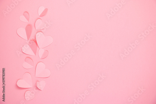 Paper cut hearts on pastel pink background. Composition for Valentine's Day, postcard. Flat lay, top view, copy space. © Ekaterina Petrukhan