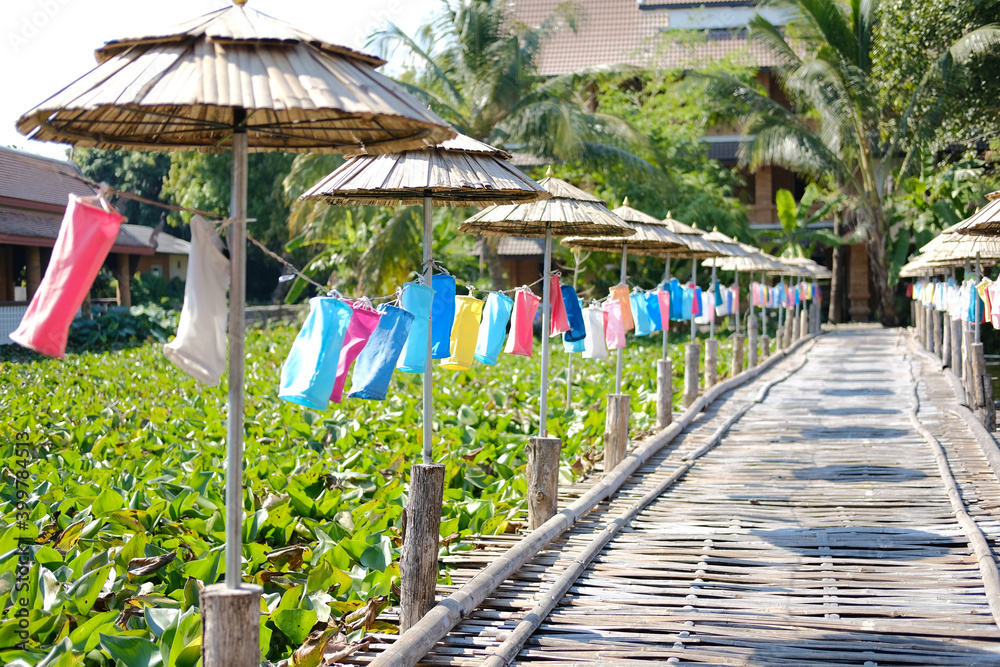 Fototapeta premium colorful fabric lamp lantern decorating along wooden bamboo bridge