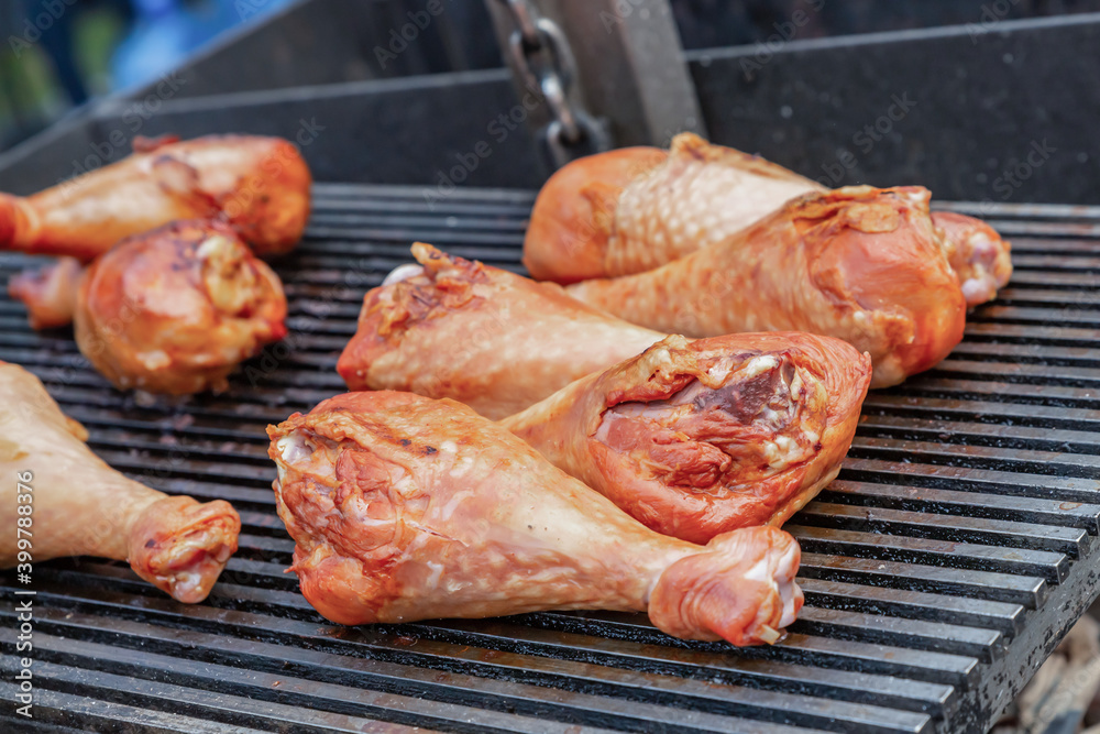 appetizing grilled turkey legs with an appetizing crust lies on a grill background
