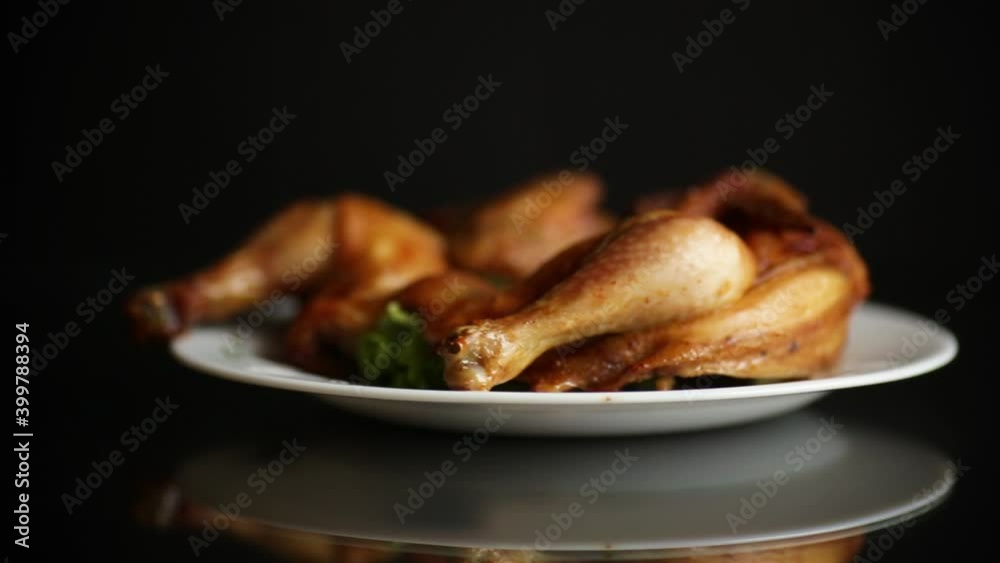 whole fried chicken in a plate on a black whole fried chicken in a plate on a black