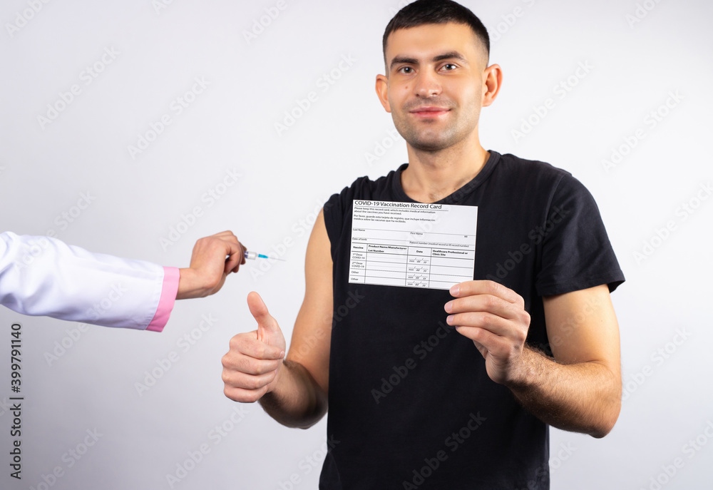 Man receives vaccine for coronavirus and holds a card showing finger thumb up. Vaccination concept. Man receives vaccine for coronavirus and holds a card showing finger thumb up. Vaccination concept.