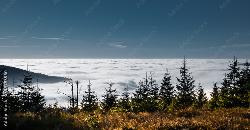 View from mountain range to the valley above fog and clouds
