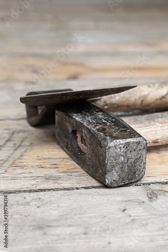 pair of builder work tools ax and heavy hammer on wooden background