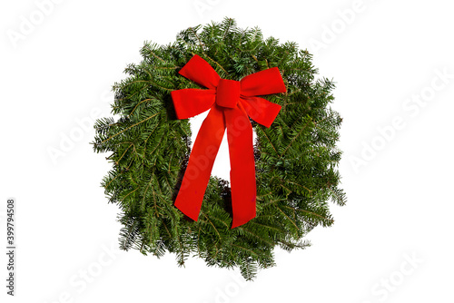 Festive evergreen Christmas wreath with red bow isolated on white background