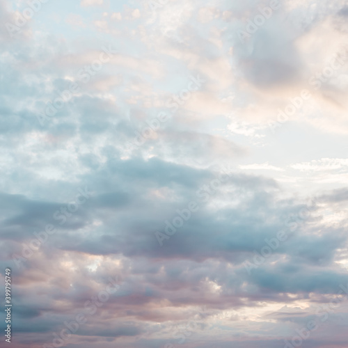 Blue sky with a pastel colored. Soft texture of fluffy clouds. Concept for airy light dreams and travel.