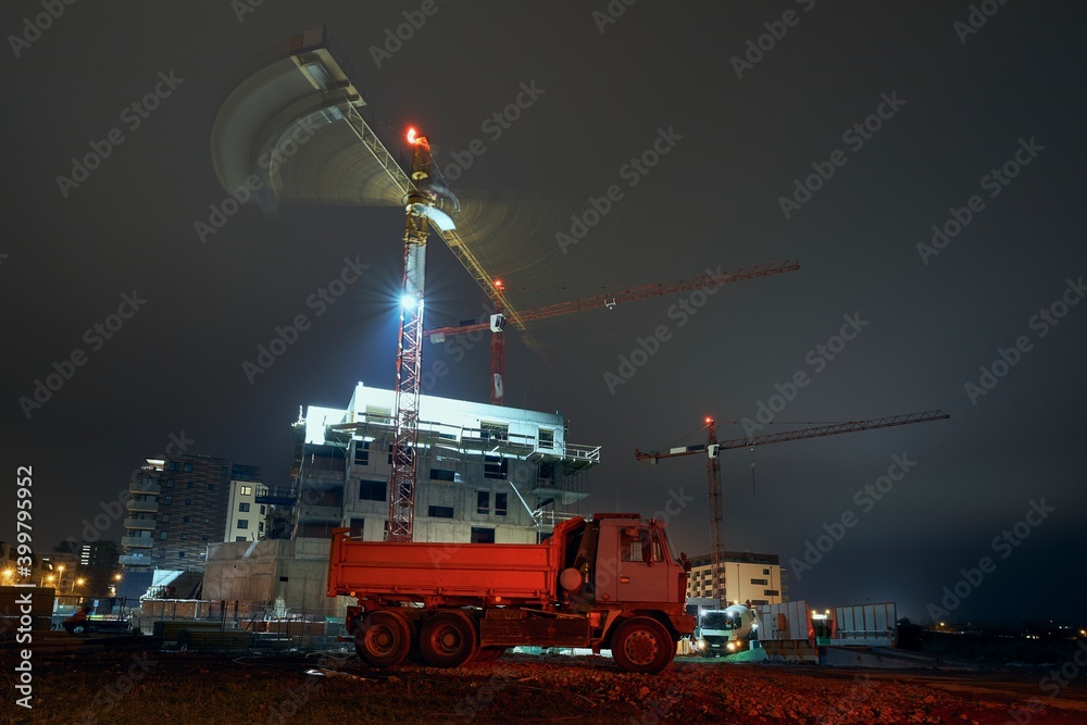 Truck against contruction site with cranes