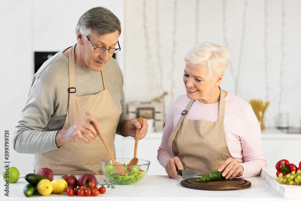Elderly Spouses Preparing Healthy Vegetable Salad For Dinner In Kitchen Elderly Spouses Preparing Healthy Vegetable Salad For Dinner In Kitchen