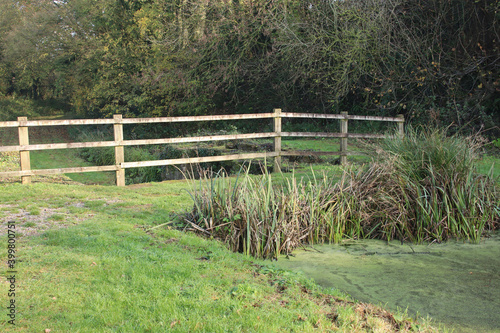 A wooden fence at the end of the Grand Western canal at Lowdwell lock in Somerset